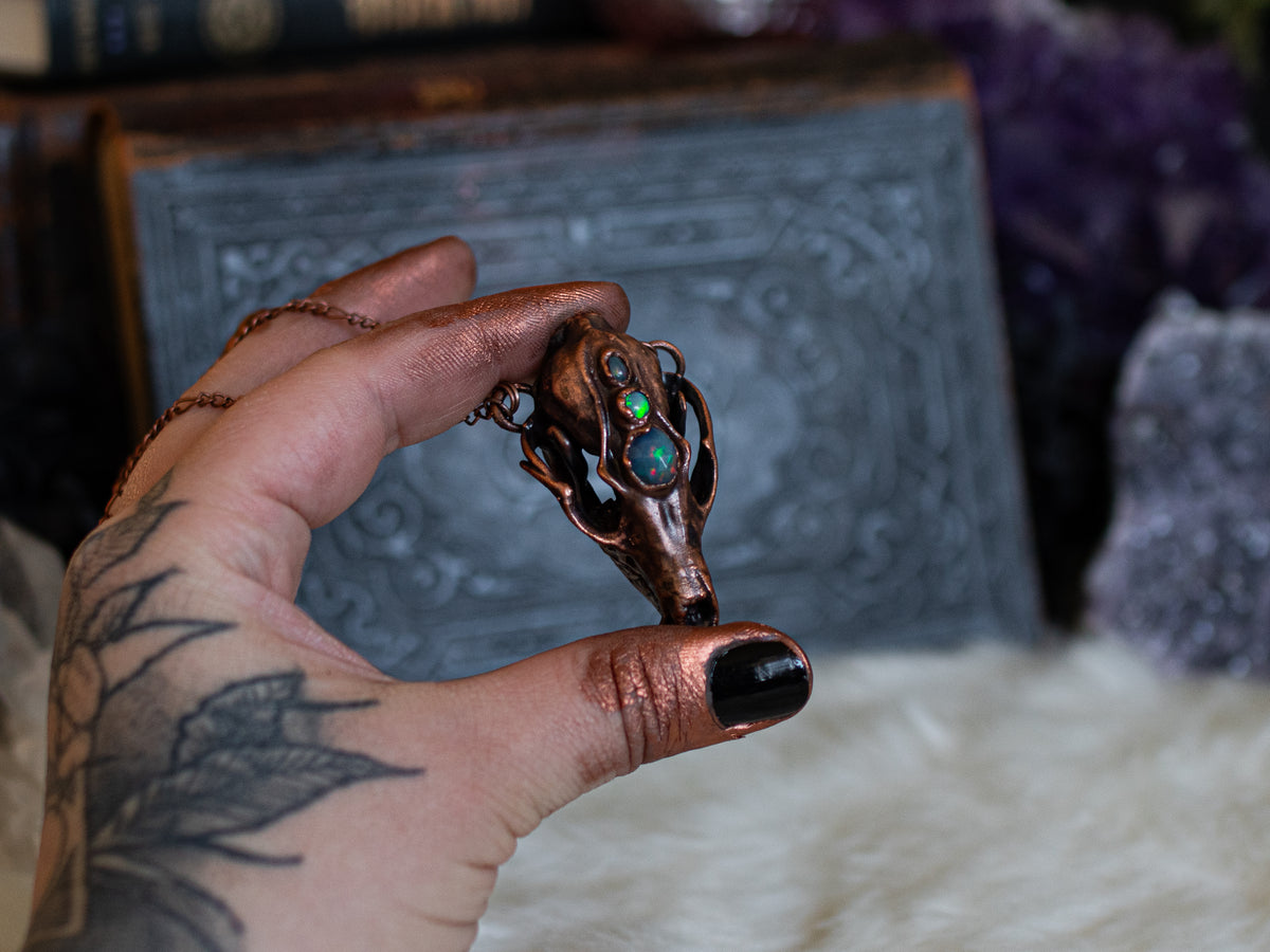 Copper fox skull pendant inspired by natural history and set with opals