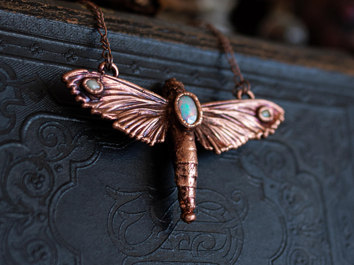Real hawk moth pendant with three Ethiopian opals in electroformed copper