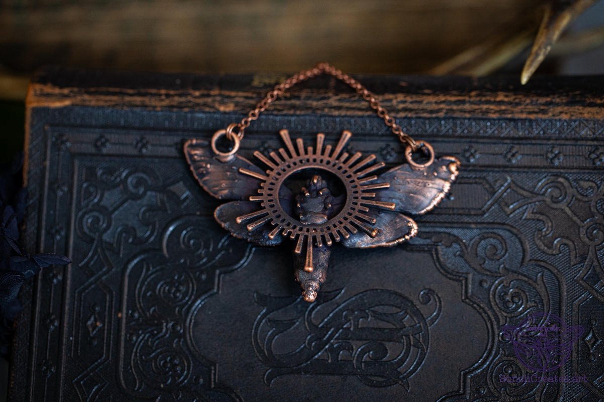 Moth pendant with warm brown vintage copper patina and citrine
