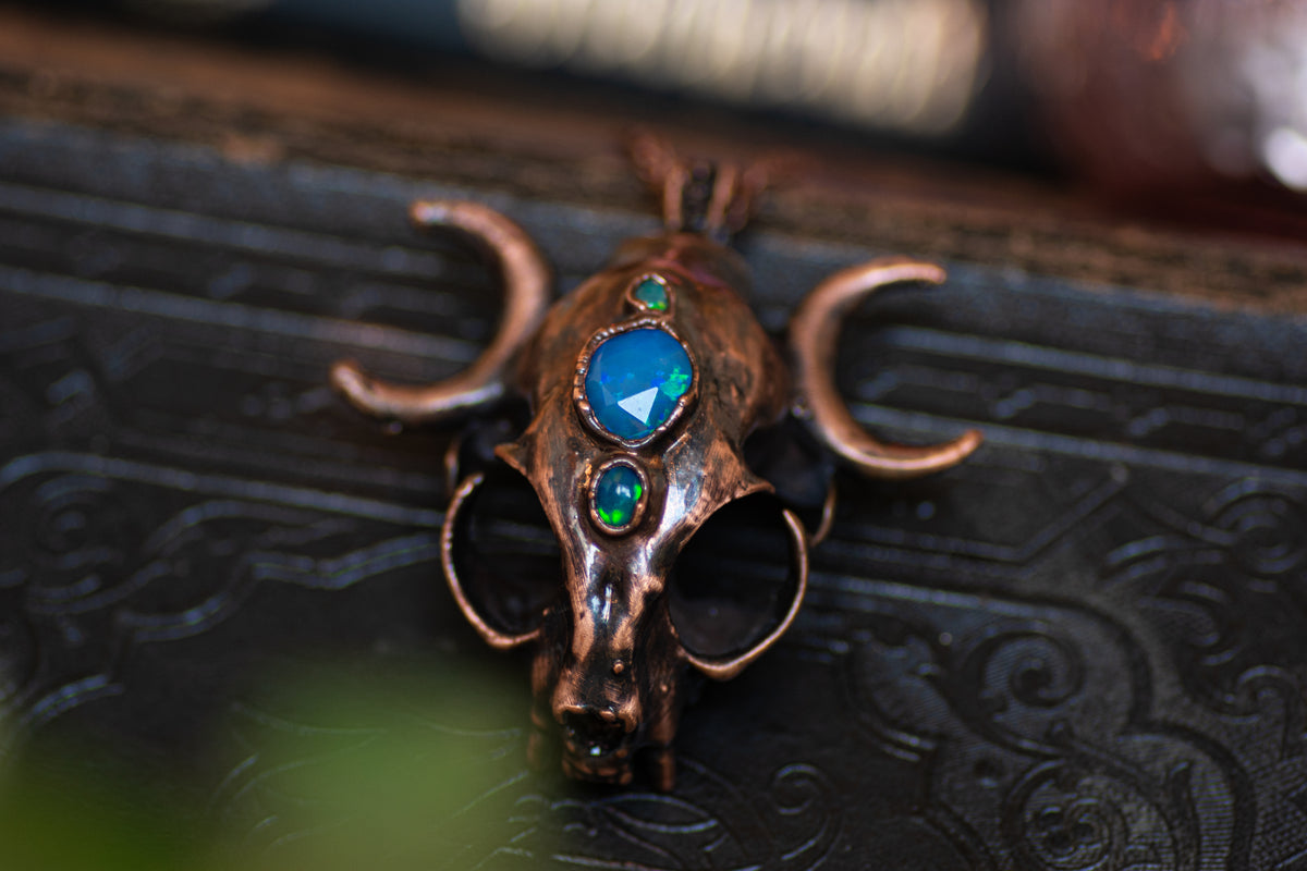 Copper cat skull pendant with three Ethiopian opals and moon-phase details