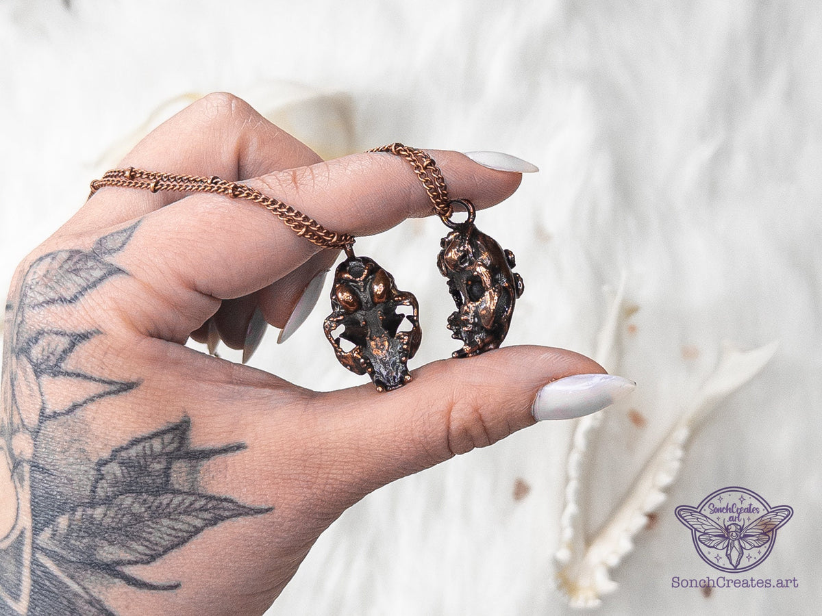 Small cat skull pendant in vintage-finish copper with gemstone details
